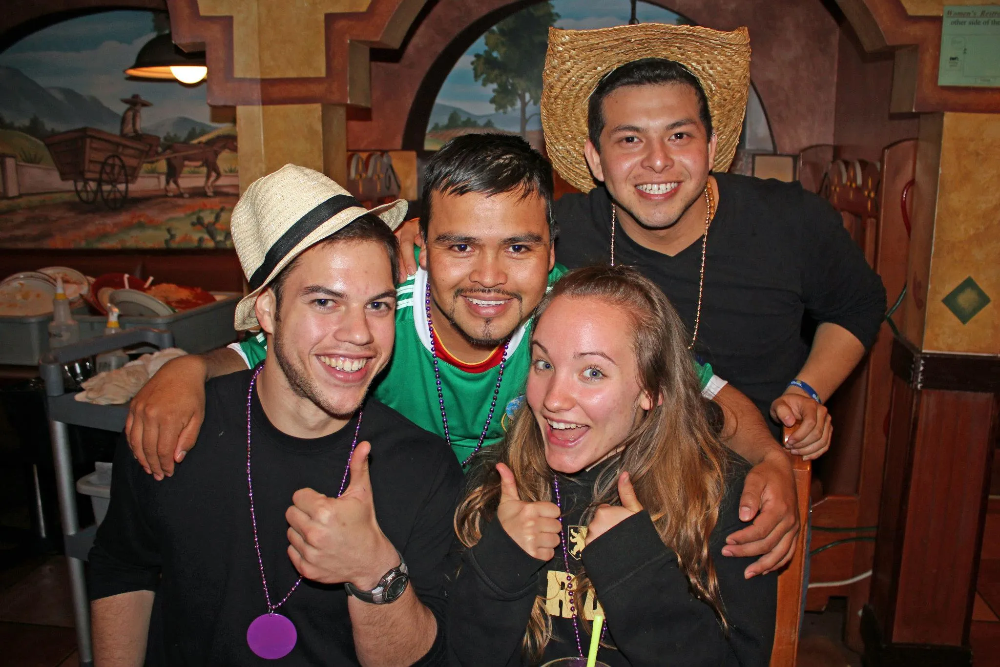A group of people smiling and having a great time at Los Arcoiris